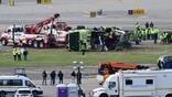 March 25, 2026, Queens, New York, Usa: (NEW) Airport maintenance crews position a tow truck as they prepare to move the wreckage of a Port Authority firetruck from the runway where it had collided with an Air Canada Express jet