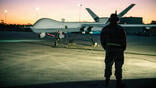 person standing by MQ-9 Reaper