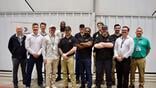 Students and instructors participating in Bombardier’s FastTrack course pose at the manufacturer’s service center at Bradley International Airport. 