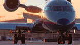 CRJ aircraft silhouetted against a light orange sky