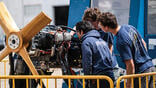 aviation maintenance students studying an aircraft engine