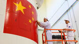 Chinese engineers check spacecraft fairing