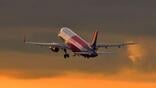Wizz Air aircraft inflight with a sunset