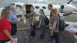 Jeff Greenberg greets players before flight 
