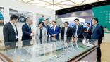 Gerald Steinhoff (second from left) shows MRO Greater China attendees the model of HAECO’s upcoming Xiamen hangar.