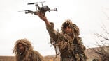 soldiers in the field with drones
