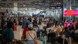 Passengers queue at airport