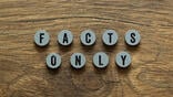wooden circular tiles reading "facts only"