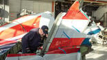 investigator studies aircraft wreckage