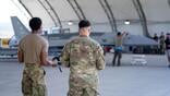 Airmen looking into a hangar