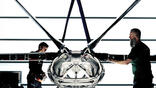 two people standing by 3D-printed aircraft fuselage