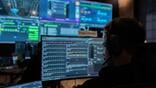 person looking at computer loading the software that guides Jackal spacecraft