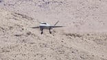 YFQ-42 coming in for a landing in desert environment