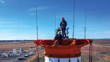 two workers standing on rocket