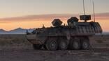 armored military vehicle in desert landscape