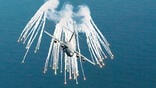 Boeing C-17 deploying flares over water