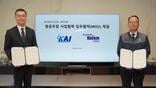 two executives hold signed documents beside screen announcing KAI–Hyundai partnership