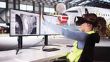 aerospace technician using a virtual reality headset to interact with 3D CAD models of an aircraft jet engine