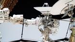 From left, Expedition 75 flight engineers Anil Menon of NASA (partially obscured and wearing the spacesuit with a red stripe on the legs) and Sophie Adenot of ESA (European Space Agency) work together during a six‑hour and 23‑minute spacewalk on Aug. 18, 2026.