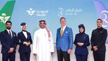 six people standing in front of screen showing Saudia and Riyadh Air logos and aircraft tails