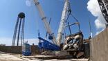 The 2 million-lb. launch table at SLC-36 was lifted out of flame trench in July for inspections and adjustments. 