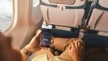 Hand holding smartphone with Alaska Airlines Starlink