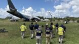 NTSB investigators approach a crashed 767F