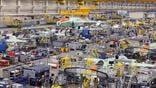 aircraft assembly factory with machinery and workers