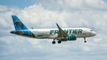 Frontier Airlines jet flying in sky
