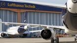 commercial lufthansa aircraft parked outside lufthansa technik hangar