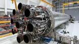 large space rocket engine displayed in an industrial hangar 