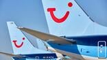 close-up of several tui aircraft sit on airport tarmac