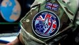 close-up of military camouflage uniform bearing uk space command patch