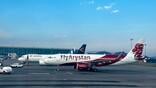 air astana and FlyArystan aircraft on an airport tarmac