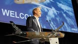Lars Wagner speaking at podium with model Airbus A350F