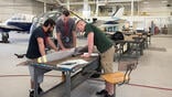 men study a propeller