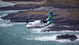 Emerald Airlines aircraft flying over the ocean