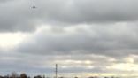landscape featuring drone flying in cloudy sky