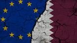 EU and Qatar flags superimposed over cracked earth