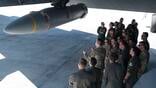 military personnel inspect missile