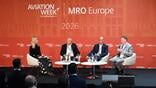 panelists and moderator onstage at mro europe