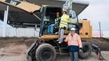 sofia airport representatives pose with an excavator 