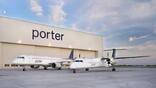 two porter dash 8 aircraft outside hangar