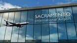 aircraft landing at sacramento international airport mirrored in terminal