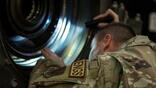 USAF technician examines engine