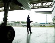 hangar with employee and aircraft