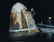 workers retrieving object from water