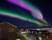 Tromsø, Norway with aurora borealis overhead