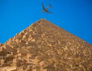 airplane over pyramid