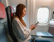 passenger using smartphone on plane